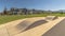 Panorama Ramp along a road and lawn in front of beautiful houses in the sunny suburbs