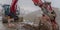 Panorama Red excavator and barricade on a muddy mountain road viewed in winter