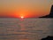 Panorama of a red sunset on the sea, the sun disappears behind the horizon