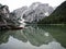 Panorama reflection boat house of Lago di Braies Pragser Wildsee alpine mountain lake Dolomites alps South Tyrol Italy