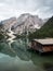 Panorama reflection boat house of Lago di Braies Pragser Wildsee alpine mountain lake Dolomites alps South Tyrol Italy