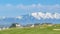 Panorama Residential area overlooking a lake and snow peaked mountain under blue sky