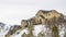 Panorama Residential area on a snowy hill with conifers and leafless trees in winter