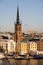 Panorama with Riddarholm Church and colorful houses around on sunny winter day, view from the hilltop.