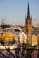 Panorama with Riddarholm Church and colorful houses around on sunny winter day, view from the hilltop.