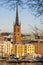 Panorama with Riddarholm Church and colorful houses around on sunny winter day, view from the hilltop.