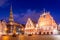 Panorama of Riga Old Town Hall Square, Roland Statue, The Blackheads House and St Peters Cathedral illuminated in the twilight,