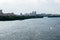 Panorama of river with boat, forest, bushes, houses