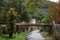 Panorama of the river Cerna in Baile Herculane, with te podul de fonta, or cast iron bridge, a rusty vintage bridge, in the middle