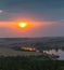 Panorama of the river, fields and forests on the background of a sunset