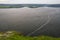 Panorama of the river and green hills and meadows in the background. The mouth of a wide flowing river with steep steep banks and