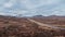 Panorama of a road leading through the Scottish Highlands