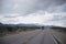 Panorama of road with semi truck with snowy mountain