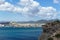 Panorama of rocky sandy coast at the sea with blue clean water and city view. Ibiza island, Spain