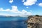 Panorama of rocky sandy coast at the sea with blue clean water and city view. Ibiza island, Spain