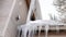 Panorama Roof of home with thick snow and sharp icicles against cloudy winter sky