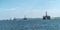 Panorama of a row of decommissioned oil rigs, Cromarty Firth, Sc