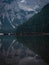 Panorama rowing boat reflection of Lago di Braies Pragser Wildsee alpine mountain lake Dolomites alps South Tyrol Italy