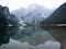 Panorama rowing boat reflection of Lago di Braies Pragser Wildsee alpine mountain lake Dolomites alps South Tyrol Italy