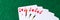 Panorama. Royal flush of hearts on green background. Winning hands of poker playing cards