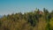 Panorama of Roznik hill with small red church hiding behind the trees in early morning sun