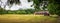 Panorama of the run for horses. Brick barn with photovoltaic panels on a corrugated roof. Beautiful rural landscape. Zwierzyniec,