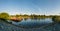 Panorama of sacramento river from levee with barge at sunset