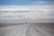 Panorama of the Salar of Uyuni with silhouette of 4x4 cars, Boli