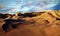 Panorama of sand dunes Sahara Desert at sunset. Endless dunes of yellow sand. Desert landscape Waves sand nature