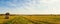 Panorama of scenic view of hay stacks at fall