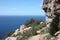 Panorama on the sea of â€‹â€‹Cala D`Hort among the rocky, rocky and arid cliffs in front of the almost Caribbean blue Ibizan sea