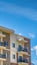 Panorama Serene blue sky with puffy clouds over a residential building on a sunny day