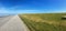 Panorama of Sheep grazing on a dike in East Frisia Ostfriesland,Germany, on the North Sea shore on a beautiful summer day with