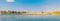 Panorama showing lake water, reed island and boat peer wit copy space