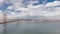 Panorama showing Lisbon cityscape and Tagus river timelapse with 25 of April bridge