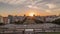 Panorama showing sunset over lawn at Alameda Dom Afonso Henriques and the Luminous Fountain aerial timelapse in Lisbon.