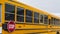 Panorama Side view of a school bus on a road passing through snowy homes in winter