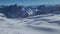 Panorama of ski resort in the german alps. Skiers on a slope on a sunny winter day