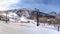 Panorama Ski resort with ski lifts under a cloudy blue sky on a sunny winter day