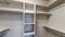 Panorama Small empty walk-in closet with shelves and metal rods