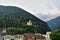 Panorama of a small town near the Alpine mountains, a castle is visible on the hill