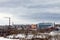 Panorama of a small winter town. Houses, churches, pipes.