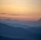 Panorama, smoky silhouette of the Carpathian mountains at sunset