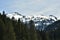 Panorama of snow-covered Alps from tourist path heading directly towards to Murg lakes