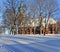 Panorama of a snow-covered city park with long shadows on a sunny day in Riga