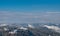 Panorama of a snow covered wooded mountain