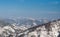 Panorama of a snow covered wooded mountain