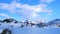 Panorama of snow mountain and frozen Alpine lake in winter, rolling white clouds, time-lapse, Switzerland