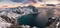 Panorama of Snowy mountain range with coastline at sunset