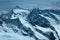 Panorama of snowy mountains and high alpine peaks in wintery Bernese Oberland in Switzerland